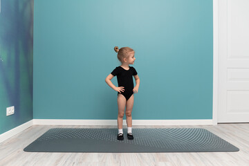 A little girl does gymnastics. Sport