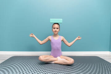 A young girl is engaged in gymnastics