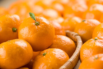 Fresh mandarin oranges fruit or tangerines with leaves in a bow