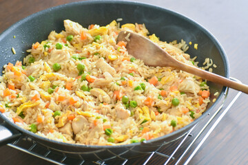 Fototapeta na wymiar Chicken and egg fried rice in a frying pan. 