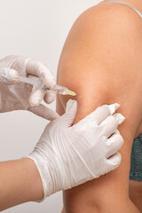doctor cosmetologist makes an injection in the arm of the patient. mesotherapy procedure to remove...