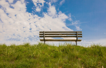 Empty bench in the blue sky background.