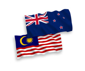 National vector fabric wave flags of New Zealand and Malaysia isolated on white background. 1 to 2 proportion.