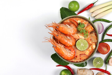 Tom yum kung spicy. Tom Yum kung in a green bowl with ingredients on a white background, top view have copy space.