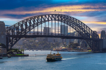 Naklejka premium Sydney Harbour Australia with nice colours in the sky. Nice blue water of the Harbour, high rise offices and residential buildings of the City in the background, NSW Australia