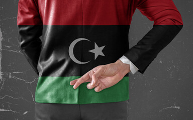 Businessman Jacket with Flag of Libya with his fingers crossed behind his back