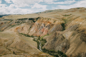 Fantastic mountain natural landscape with bright red and orange colors transitions and blue clear sky in place named Mars, Altai Republic, Russia. Unearthly Martian landscapes.