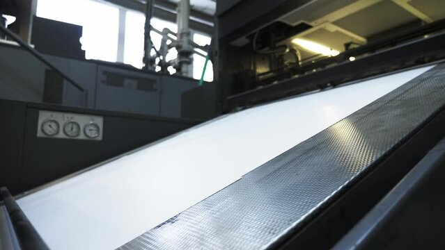 Printed sheets of paper are served in the printing press offset printing