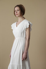 Obraz premium Studio shot of woman in long white summer dress. 