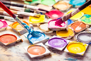 Obraz premium Colors and brushes on wooden background