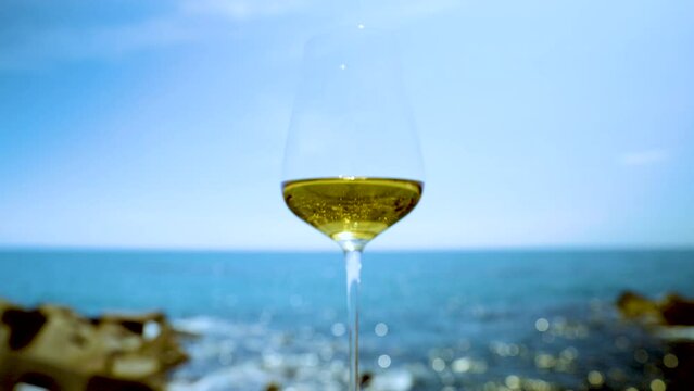 White wine in glass against the sea