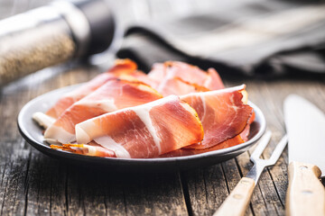 Sliced schwarzwald ham. Dried prosciutto ham on plate.