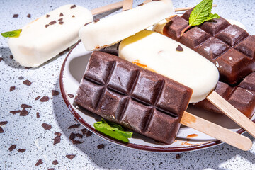 Chocolate and vanilla popsicles, Classic dark brown cocoa and milk cream ice cream lolly pops. Stack of various ice-cream lollies flatlay top view copy space
