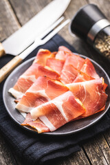 Sliced schwarzwald ham. Dried prosciutto ham on plate.