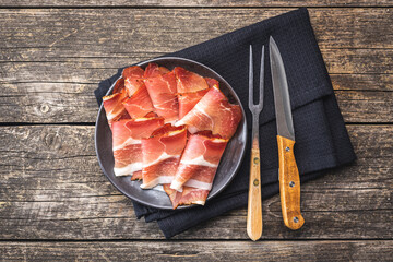 Sliced schwarzwald ham. Dried prosciutto ham on plate. - obrazy, fototapety, plakaty
