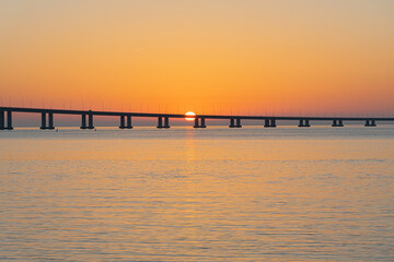 Fototapeta premium sunrises at the basque bridge of gama in lisbon, colors of the golden hour of the morning. basque bridge of gama