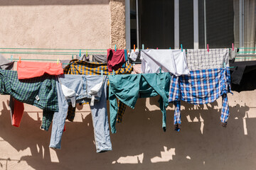 Clothes of different colors drying on a clothesline.