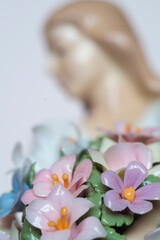 Obraz na płótnie Canvas beautiful porcelain doll with flowers