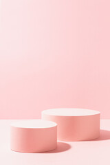 Sweet girlish pastel pink stage mockup with two circle podiums in sunlight with shadow for advertising, presentation cosmetic product or goods, design on soft light background, copy space, vertical.
