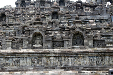 Some headless Buddha statues meditating at Borobudur temple of Indonesia