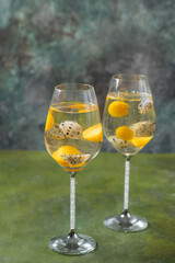 Dessert champagne jelly with exotic fruits - mango and pitahaya in a glass. On a black background