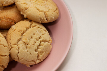 homemade round cookies on pink plate with copy space