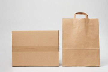 Cardboard box and paper bag on isolated on white