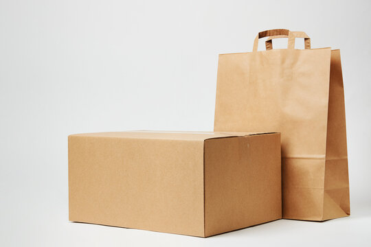 Cardboard box and paper bag on isolated on white