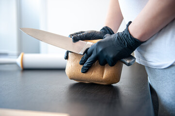 Close-up, a piece of dough in female hands, working with dough.