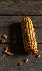 Dried corn on a wooden table texture. Head of corn. Food. Close. Yellow corn. Concept: market, food, vegetables, cereals