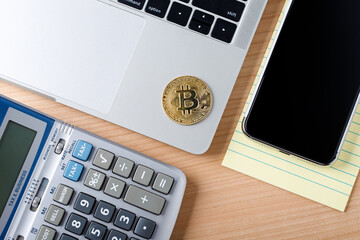 Bitcoin standard BTC crypto currency on laptop computer, Top view mock up on wooden table