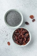 Bowls with poppy seeds and raisins