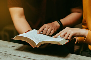 Christian couples read and study the Bible at home or in Sunday school. Sunday readings, spirituality, and religion Concept. - obrazy, fototapety, plakaty
