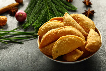 Obraz na płótnie Canvas Homemade fresh baked curry puffs on a rustic kitchen table background.