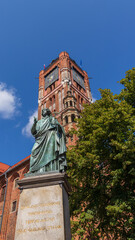 view of the high clock tower in the city of Torun