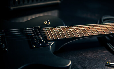 Fototapeta na wymiar Close-up, black electric guitar on a dark background.