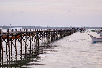 Seascape with wooden pier and fishing boat. Siargao, Philippines.