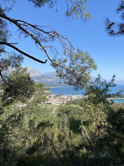 Fototapeta na wymiar Panoramic view of Kemer, Turkey. View from the height through the pine trees of the Mediterranean coast. Chalysh mountain in Kemer, Turkey