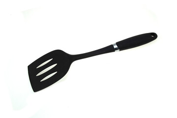 Black plastic turner placed on a white background.