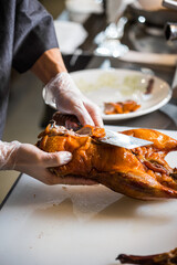 chinese chef cooking peking roasted duck at the kitchen of restaurant