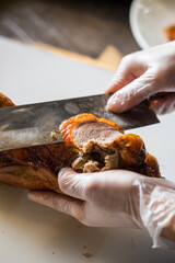 chinese chef cooking peking roasted duck at the kitchen of restaurant