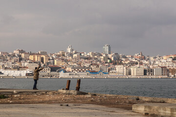 Fototapeta na wymiar Man fishing on the shore of the Bosphorus in istanbul