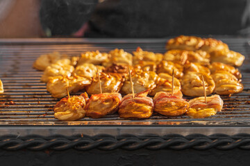 Bacon on wheat bun - natural traditional grilled street snack, steam over food, outdoor barbecue in Krakow, Poland