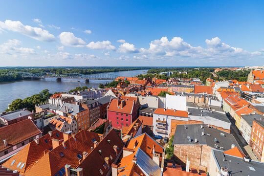 view of the old town of Torun and the Vistula river from above during a warm summer day.