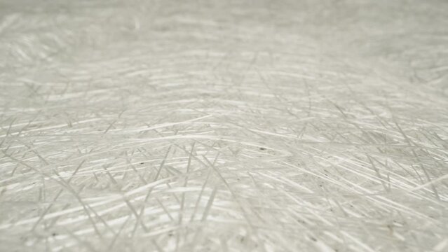 Camera flight from above, over sheets of white fiberglass. Dolly slider extreme close-up. Laowa Probe