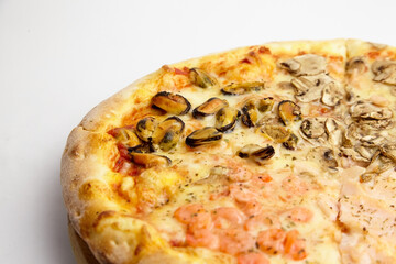 Seafood Pizza mix with mussels and shrimps on wooden cutting board on white