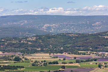 Panoramic view Luberon hills covered with lavender fields, vineyards, apple orchards, forests from top of historic hill village Bonnieux, Vaucluse, Provence, France