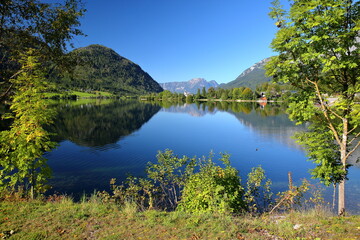 Reflections on Grundlsee lake (Eastern part) and colorful scenery, Salzkammergut, Styria, Austria, Europe