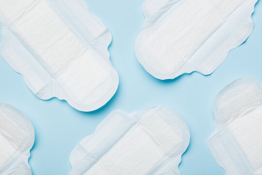 Women hygiene products or sanitary pad on colored background. Pastel color. Closeup. Empty place for text. Female daily hygiene