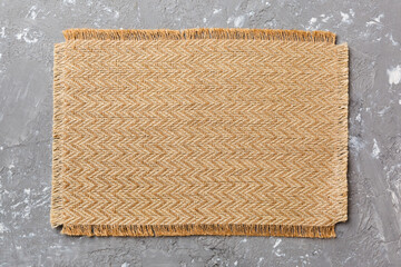 Fototapeta premium Top view of brown tablecloth for food on cement background. Empty space for your design